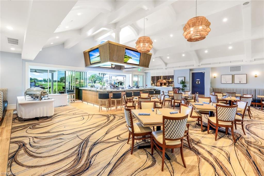 11822 Quail Village Way Naples, FL 34119 - Photo 33 of 34 a view of a dining room with furniture and chandelier