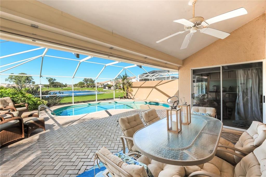 11822 Quail Village Way Naples, FL 34119 - Photo 5 of 34 a dining room with furniture and a floor to ceiling window