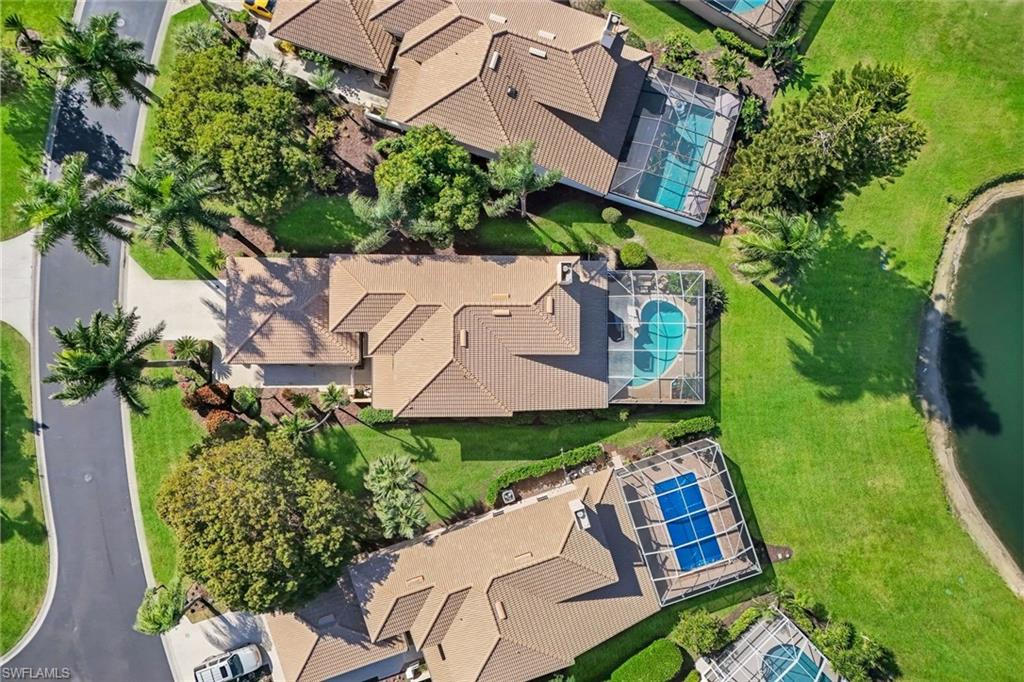 11822 Quail Village Way Naples, FL 34119 - Photo 6 of 34 an aerial view of a house with garden space and street view