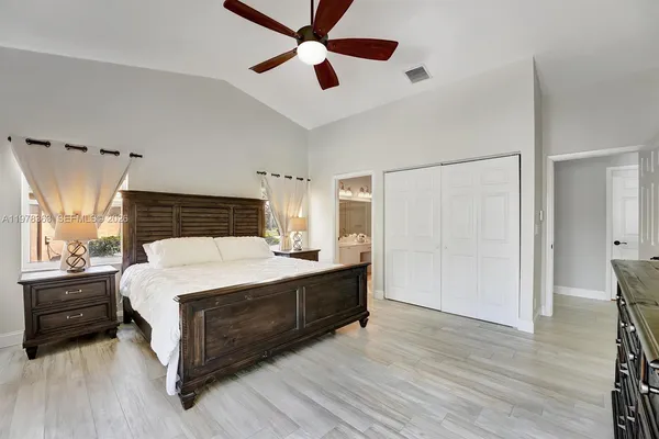 a spacious bedroom with a bed and a chandelier