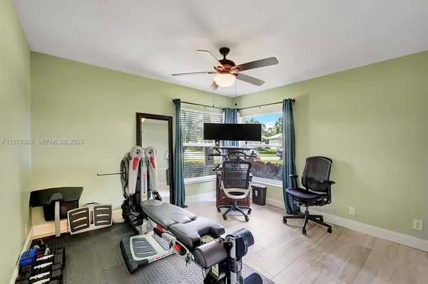 a view of a workspace with furniture and a window