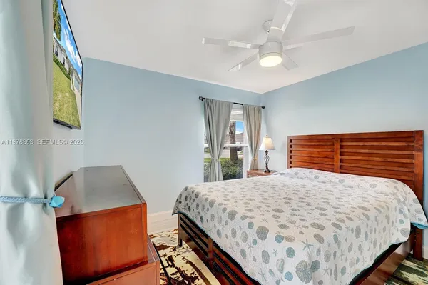 a bedroom with a bed and dresser with mirror