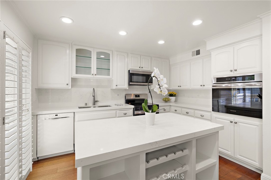 5 Morningside Irvine, CA 92603 - Photo 12 of 58 a kitchen with a sink a stove and cabinets