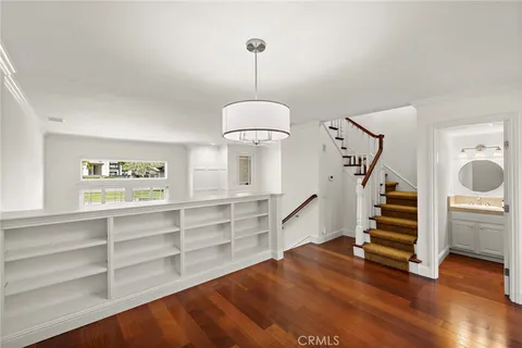a kitchen with stainless steel appliances granite countertop a stove and a wooden floors
