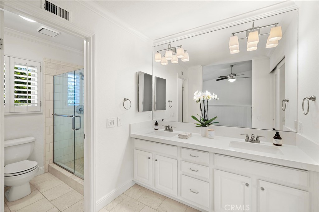 5 Morningside Irvine, CA 92603 - Photo 23 of 58 a bathroom with a double vanity sink mirror and toilet