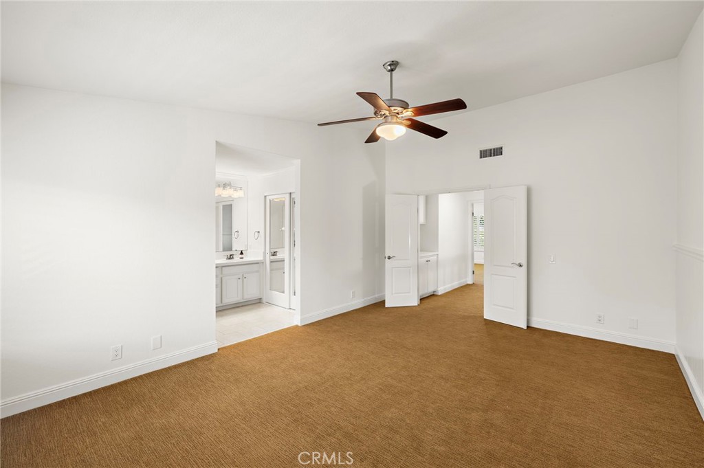 5 Morningside Irvine, CA 92603 - Photo 27 of 58 a view of a big room with wooden floor and a ceiling fan