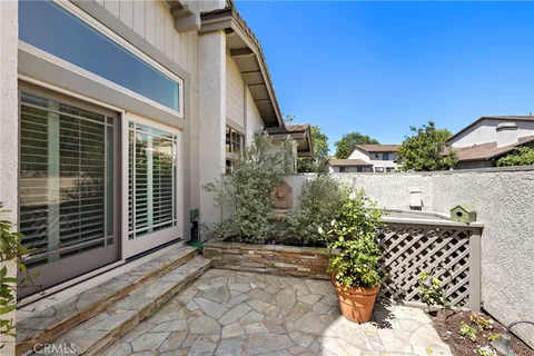 a view of backyard with a garden and a bench