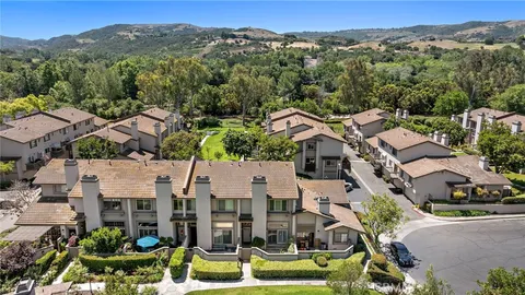 an aerial view of a house with a yard