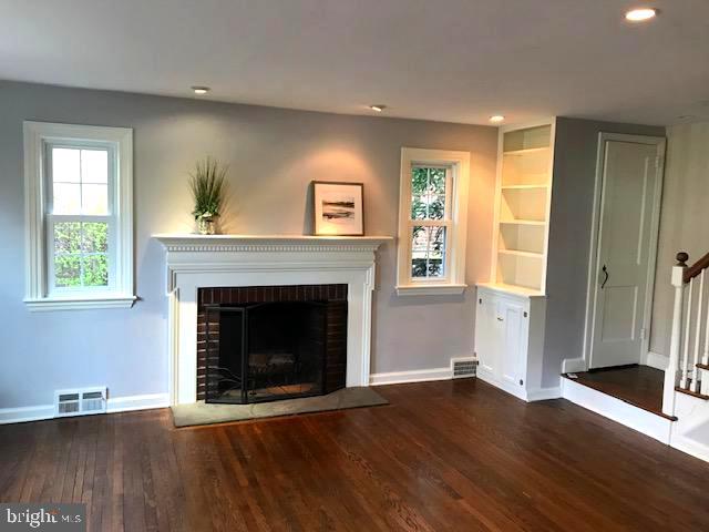 226 Crosshill Road Wynnewood, PA 19096 - Photo 4 of 26 a living room with wooden floors and a fireplace