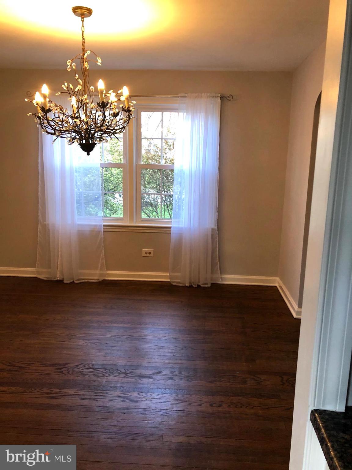 226 Crosshill Road Wynnewood, PA 19096 - Photo 9 of 26 a view of a room with wooden floor and chandelier