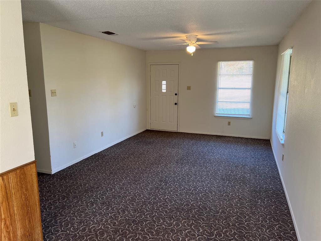 3711 Greenwood Road Weatherford, TX 76088 - Photo 7 of 15 an empty room with windows and fan
