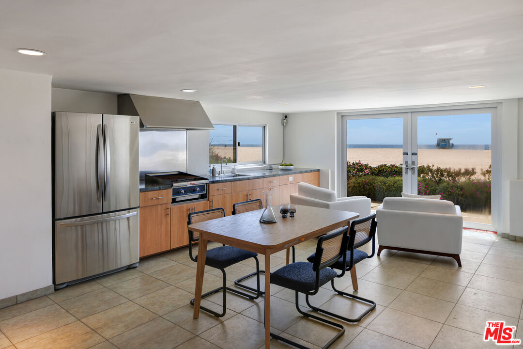 3412 Ocean Front Walk, Unit 201 Marina del Rey, CA 90292 - Photo 18 of 23 a kitchen with a refrigerator a stove a dining table and chairs