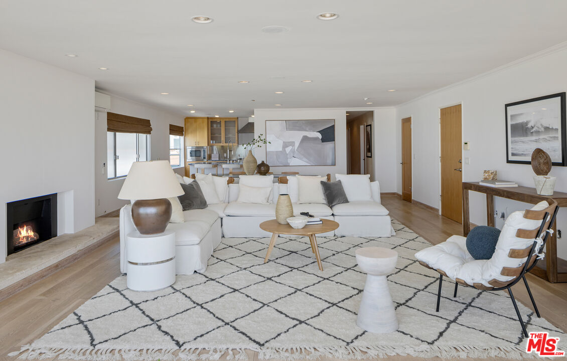 3412 Ocean Front Walk, Unit 201 Marina del Rey, CA 90292 - Photo 3 of 23 a living room with furniture and a fireplace