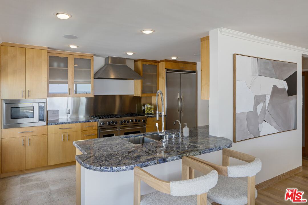 3412 Ocean Front Walk, Unit 201 Marina del Rey, CA 90292 - Photo 6 of 23 a kitchen with a sink a counter top space and stainless steel appliances