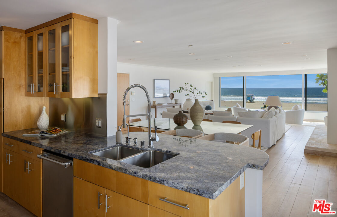 3412 Ocean Front Walk, Unit 201 Marina del Rey, CA 90292 - Photo 7 of 23 a kitchen with kitchen island granite countertop a sink and cabinets
