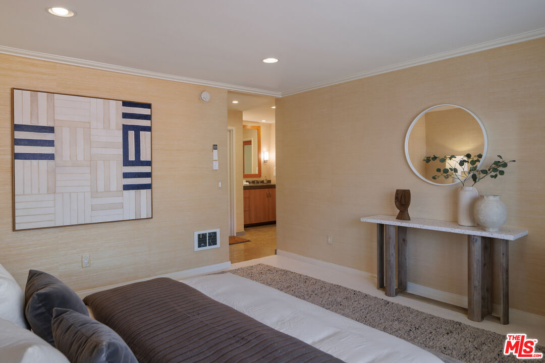 3412 Ocean Front Walk, Unit 201 Marina del Rey, CA 90292 - Photo 10 of 23 a bedroom with a large bed dresser and a chandelier