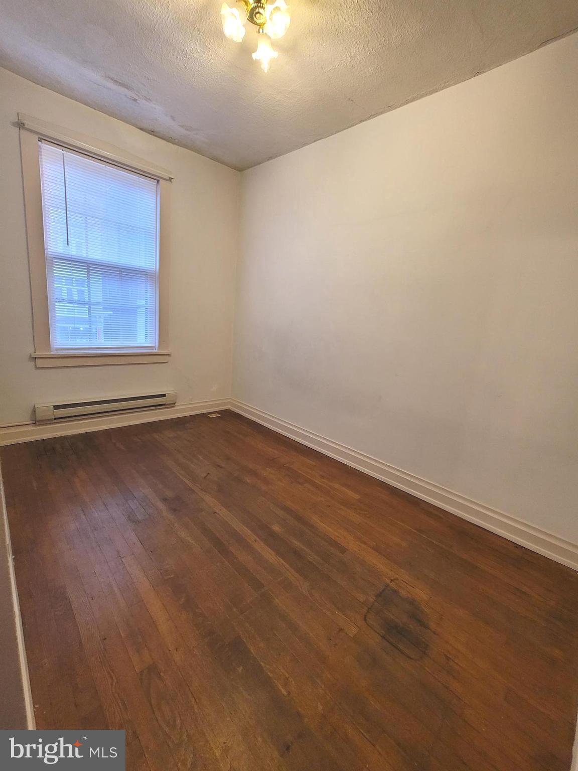 37 East Main Street, Unit 2 Waynesboro, PA 17268 - Photo 16 of 25 an empty room with wooden floor and windows