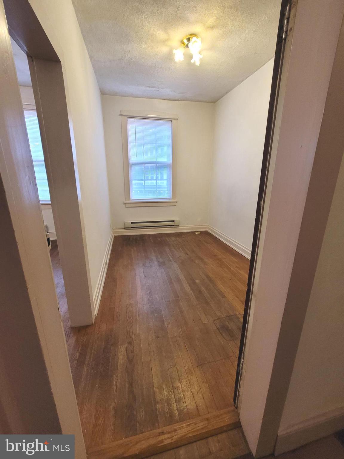 37 East Main Street, Unit 2 Waynesboro, PA 17268 - Photo 5 of 25 an empty room with wooden floor and windows