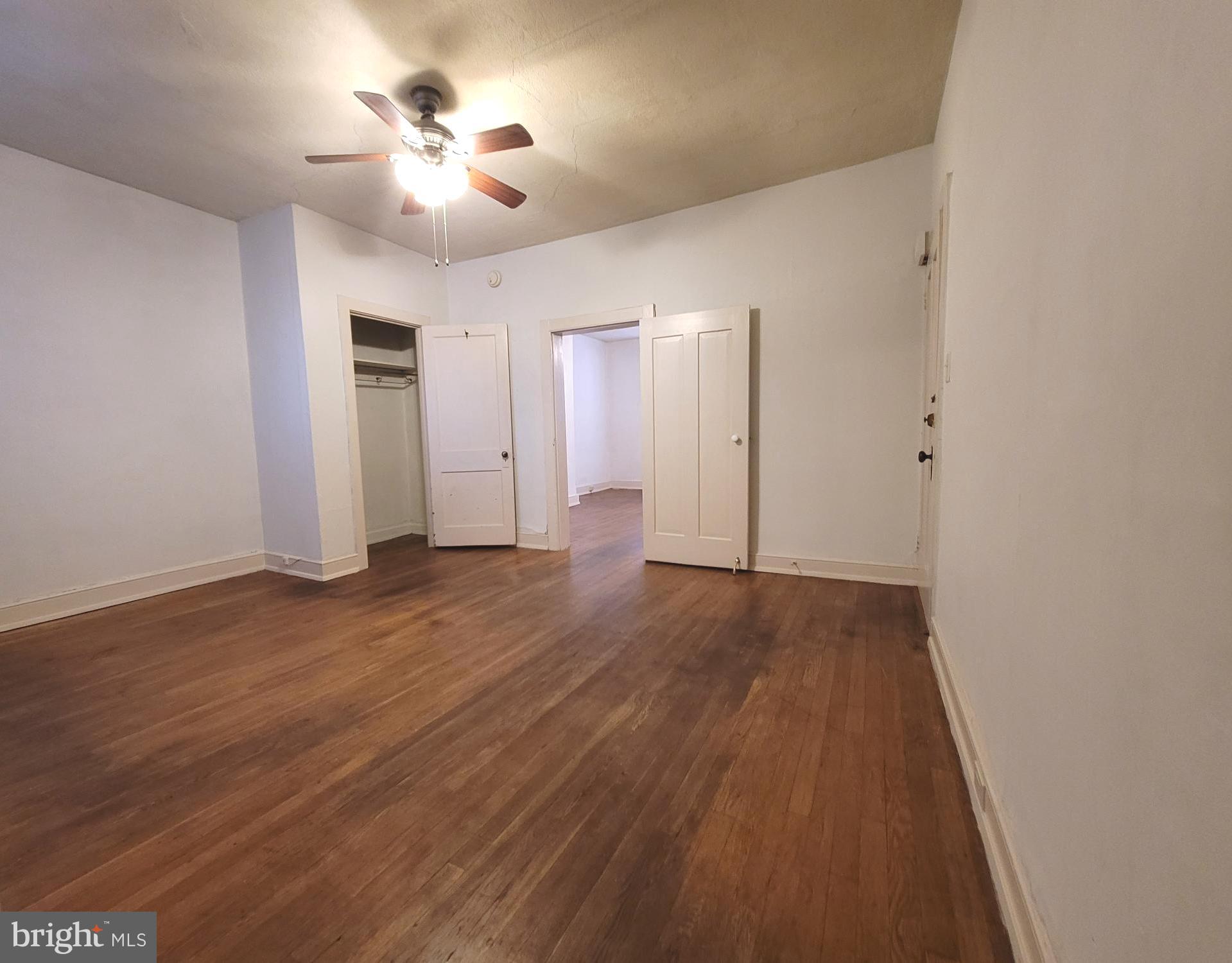 37 East Main Street, Unit 2 Waynesboro, PA 17268 - Photo 6 of 25 an empty room with wooden floor and ceiling fan