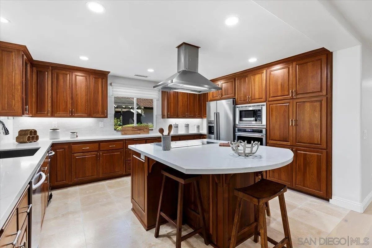 16902 Via De Santa Fe, Unit 12 Rancho Santa Fe, CA 92091 - Photo 11 of 54 a kitchen with stainless steel appliances granite countertop a sink stove and refrigerator