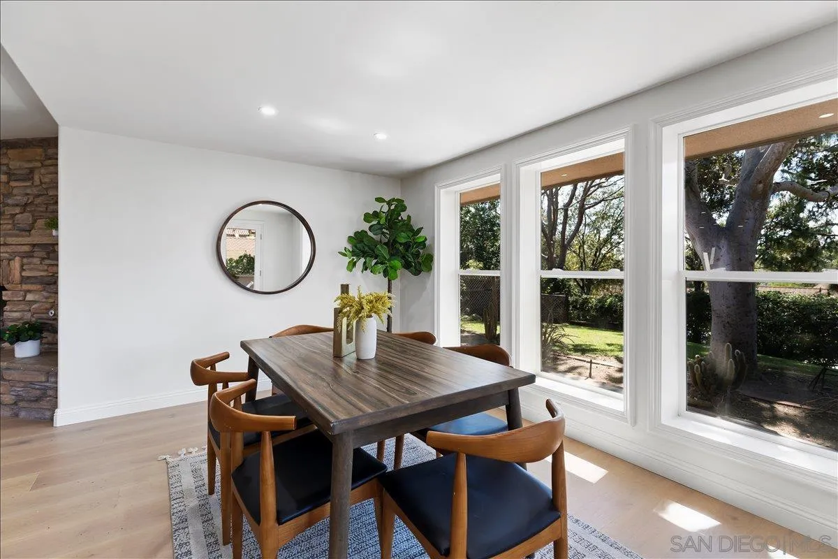 16902 Via De Santa Fe, Unit 12 Rancho Santa Fe, CA 92091 - Photo 22 of 54 a view of a dining room with furniture window and wooden floor