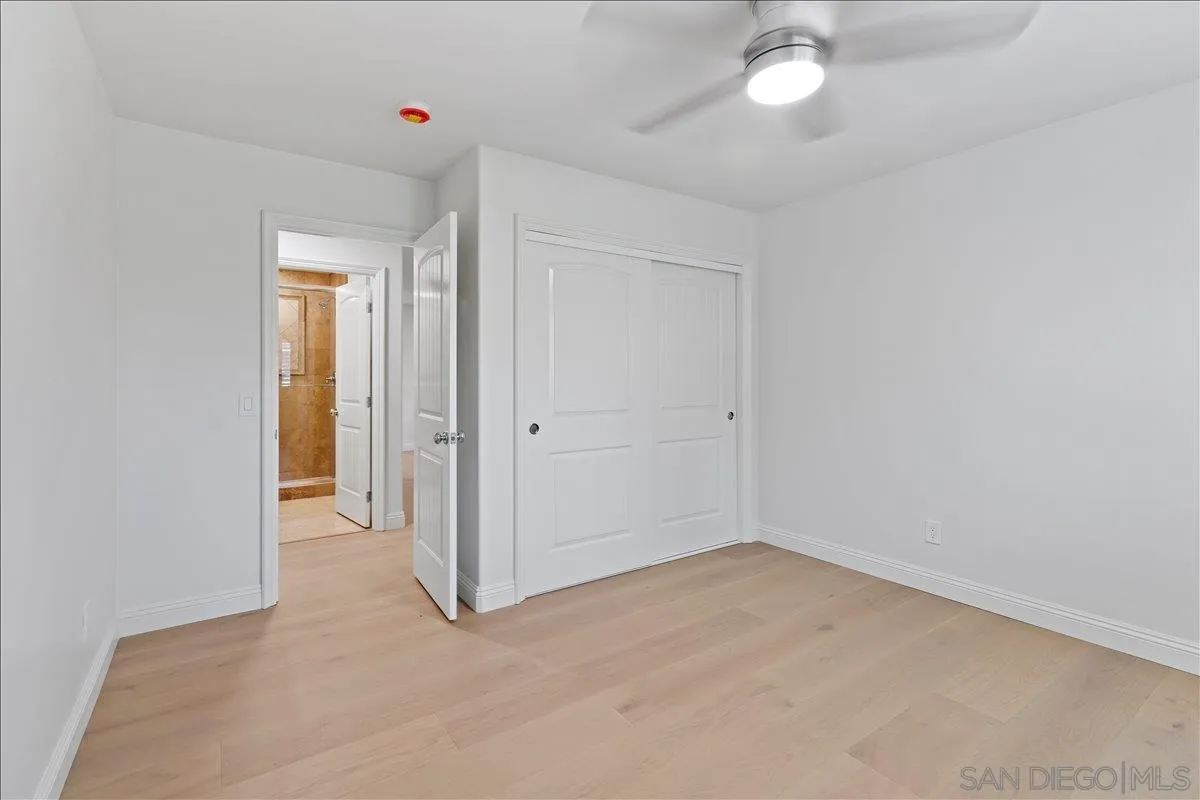 16902 Via De Santa Fe, Unit 12 Rancho Santa Fe, CA 92091 - Photo 25 of 54 an empty room with chandelier fan