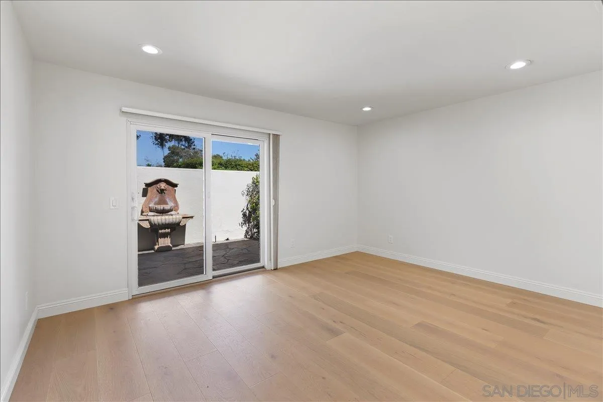 16902 Via De Santa Fe, Unit 12 Rancho Santa Fe, CA 92091 - Photo 27 of 54 a view of a big room with wooden floor and window