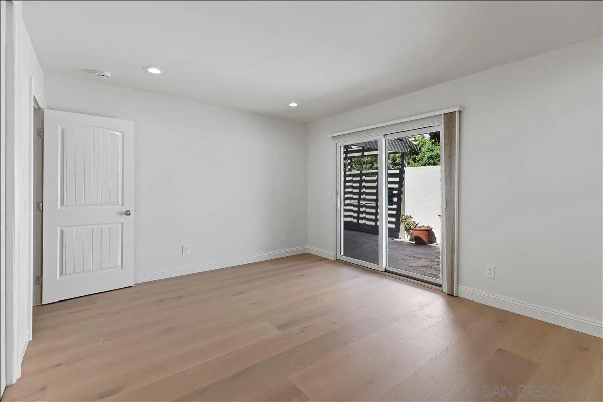 16902 Via De Santa Fe, Unit 12 Rancho Santa Fe, CA 92091 - Photo 28 of 54 an empty room with wooden floor and windows