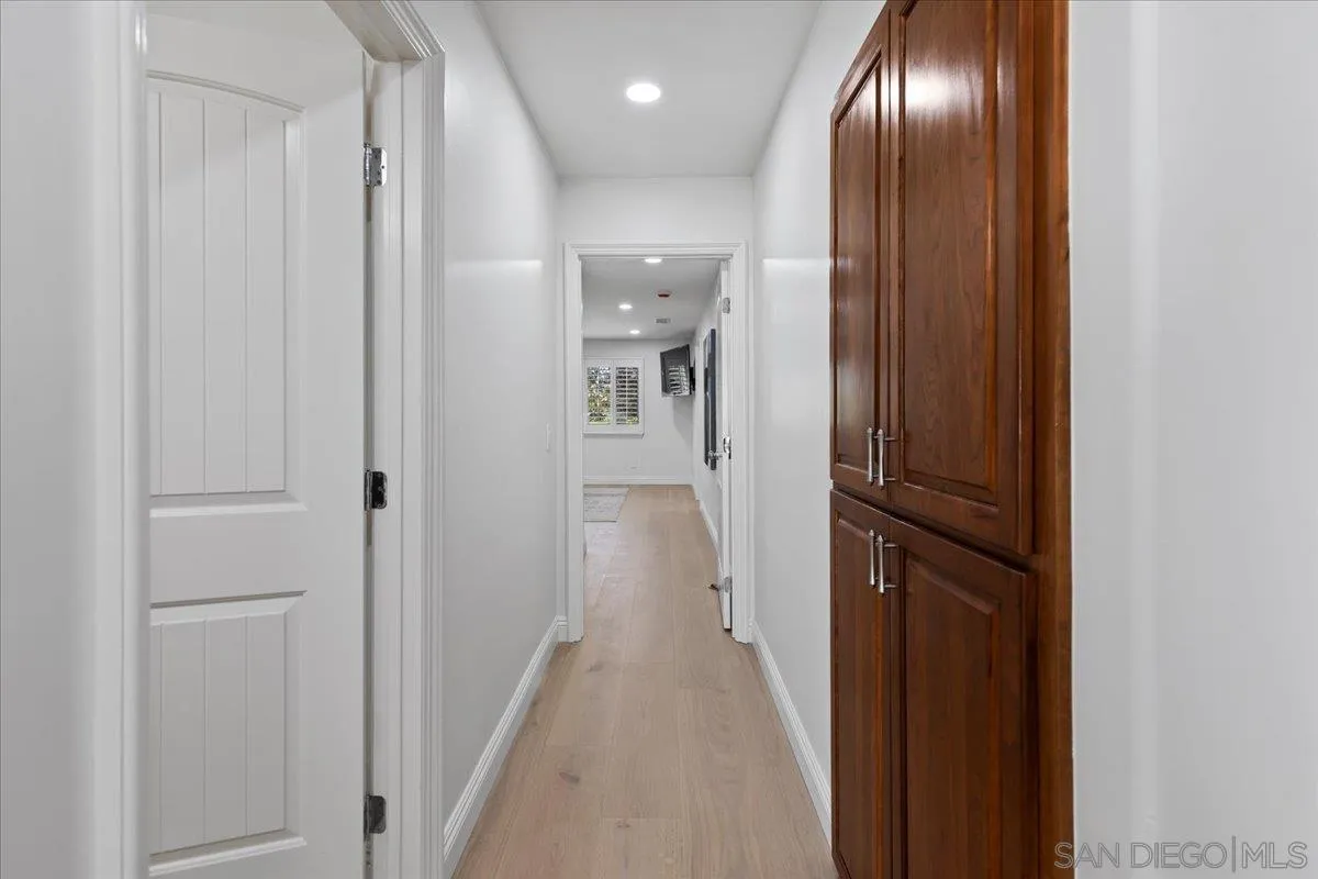 16902 Via De Santa Fe, Unit 12 Rancho Santa Fe, CA 92091 - Photo 29 of 54 a view of hallway with livingroom and wooden floor
