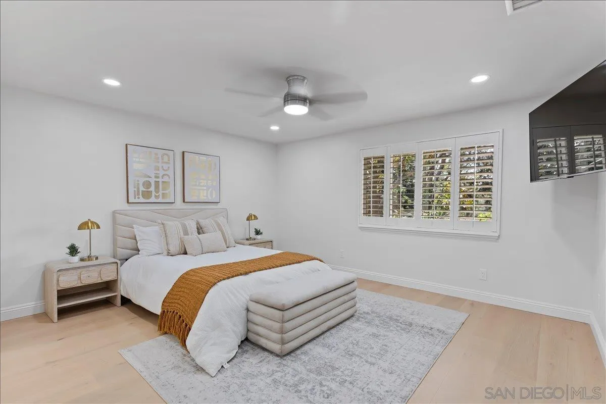 16902 Via De Santa Fe, Unit 12 Rancho Santa Fe, CA 92091 - Photo 31 of 54 a bedroom with a large bed and a window
