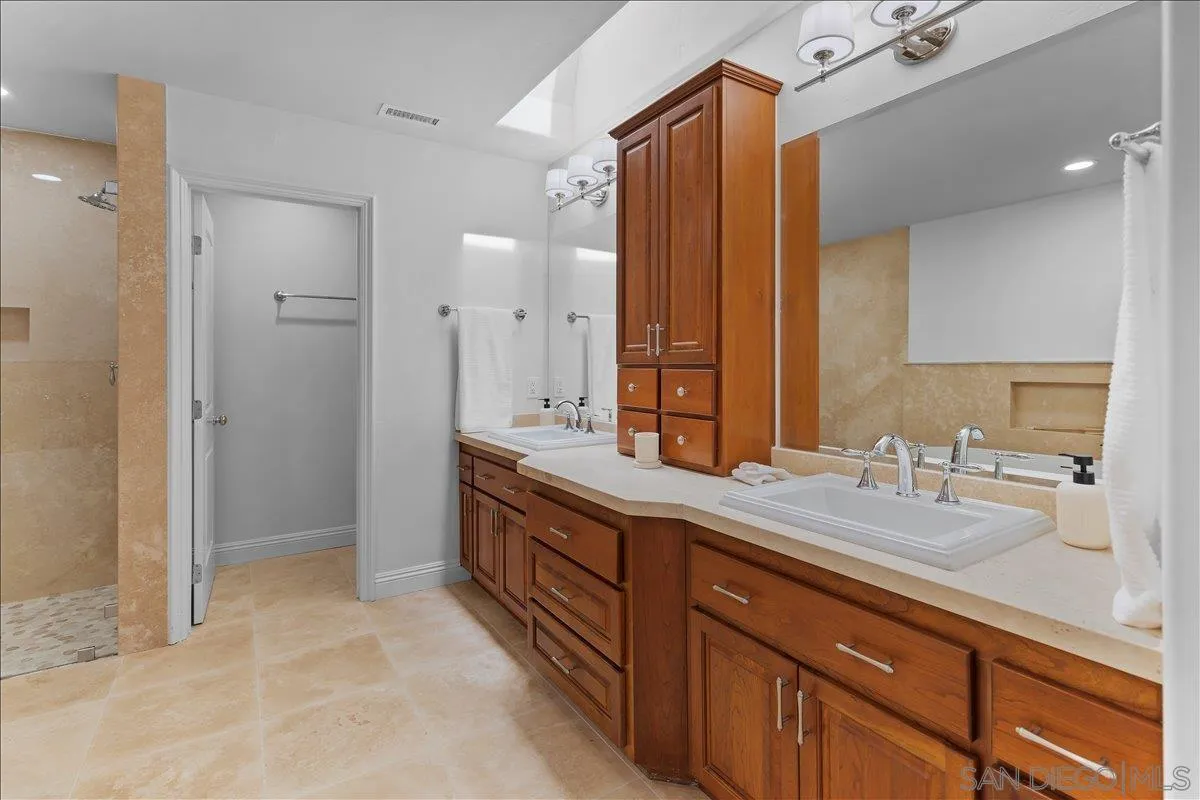 16902 Via De Santa Fe, Unit 12 Rancho Santa Fe, CA 92091 - Photo 36 of 54 a spacious bathroom with a granite countertop sink mirror and double