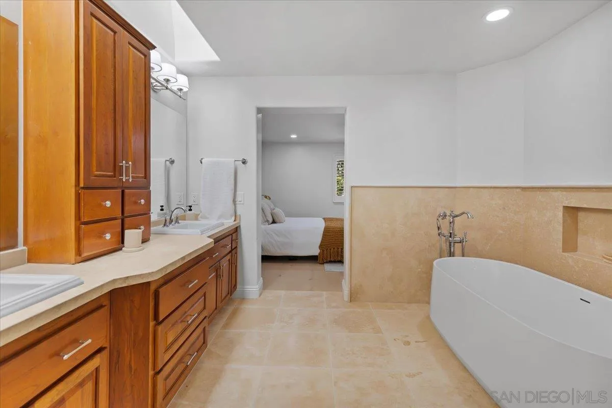 16902 Via De Santa Fe, Unit 12 Rancho Santa Fe, CA 92091 - Photo 38 of 54 a spacious bathroom with a tub sink and mirror