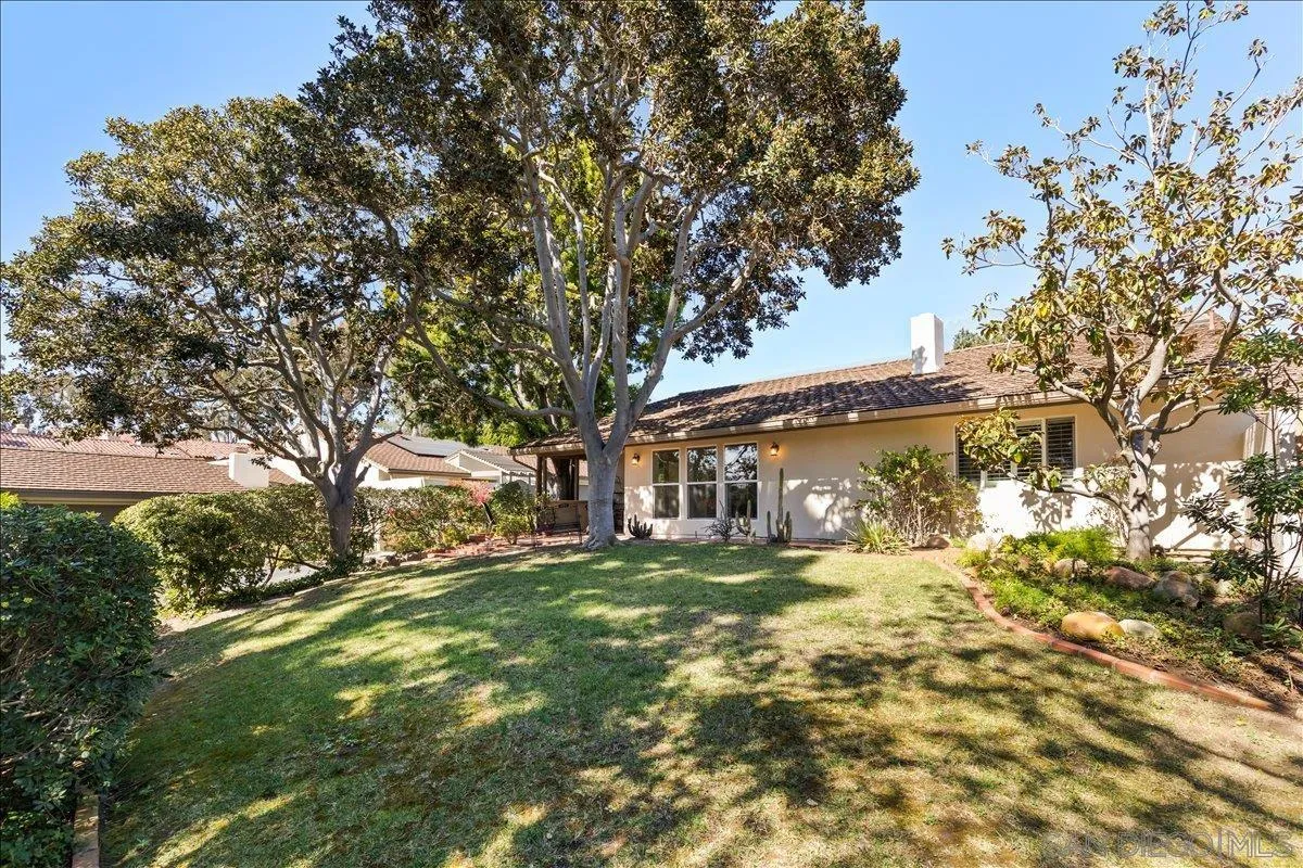 16902 Via De Santa Fe, Unit 12 Rancho Santa Fe, CA 92091 - Photo 48 of 54 a view of a yard with a house and a tree