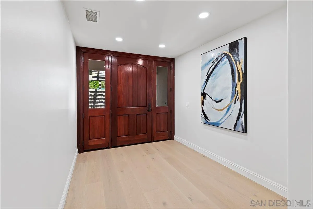 16902 Via De Santa Fe, Unit 12 Rancho Santa Fe, CA 92091 - Photo 5 of 54 a view of a hallway with wooden floor