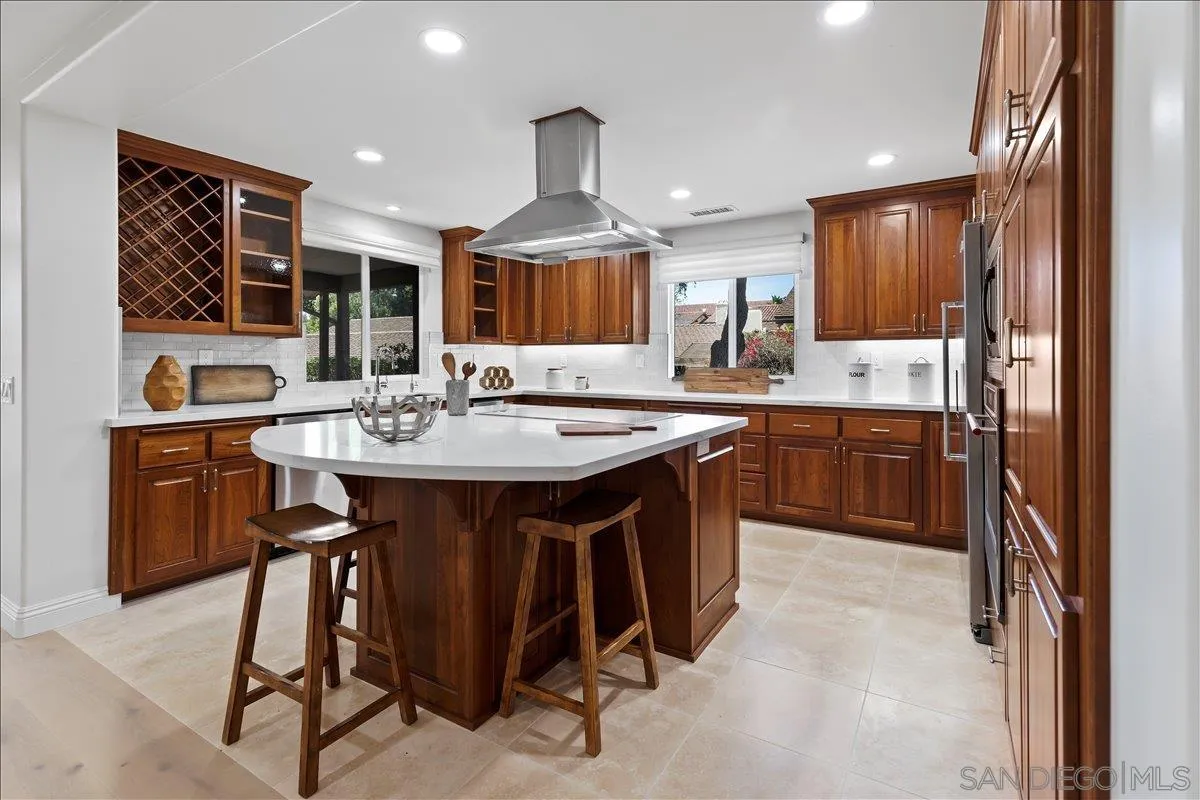 16902 Via De Santa Fe, Unit 12 Rancho Santa Fe, CA 92091 - Photo 9 of 54 a kitchen with a sink a stove a refrigerator and chairs