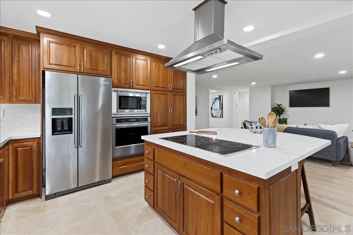 16902 Via De Santa Fe, Unit 12 Rancho Santa Fe, CA 92091 - Photo 10 of 54 a kitchen with a refrigerator a sink and cabinets