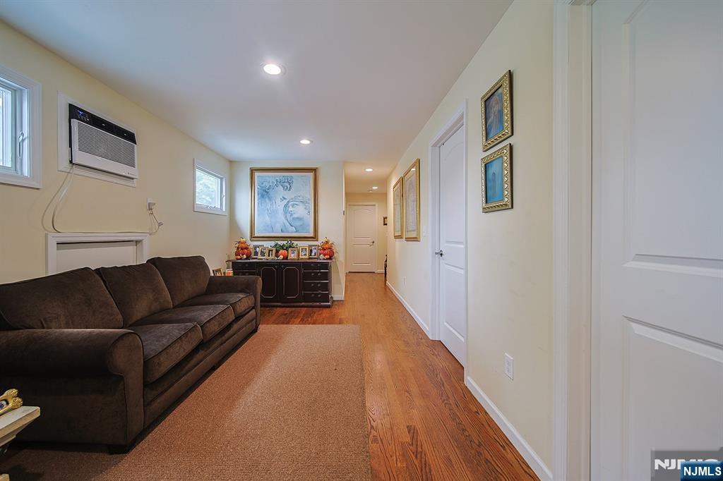 1003 Cumbermeade Road Fort Lee, NJ 07024 - Photo 11 of 23 a living room with furniture and a wooden floor