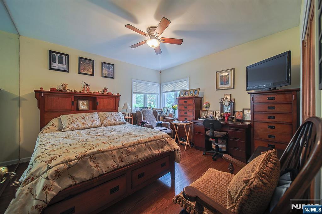 1003 Cumbermeade Road Fort Lee, NJ 07024 - Photo 13 of 23 a bedroom with a bed and a flat screen tv