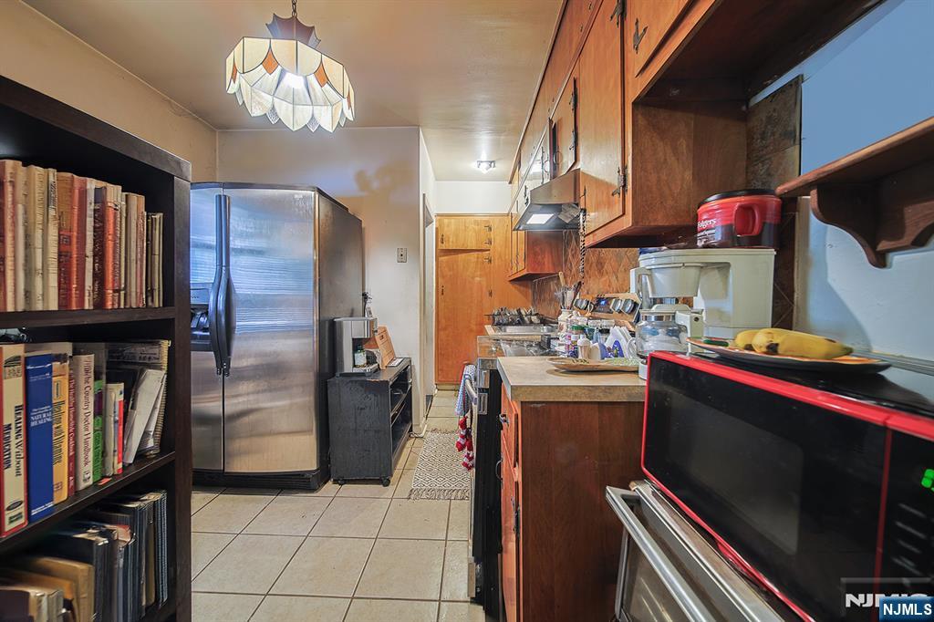 1003 Cumbermeade Road Fort Lee, NJ 07024 - Photo 18 of 23 a kitchen with stainless steel appliances granite countertop a refrigerator and a stove top oven