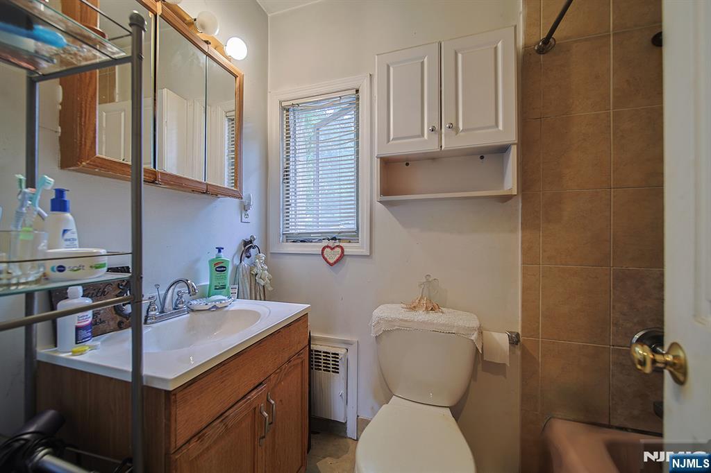 1003 Cumbermeade Road Fort Lee, NJ 07024 - Photo 19 of 23 a bathroom with a sink a toilet and mirror