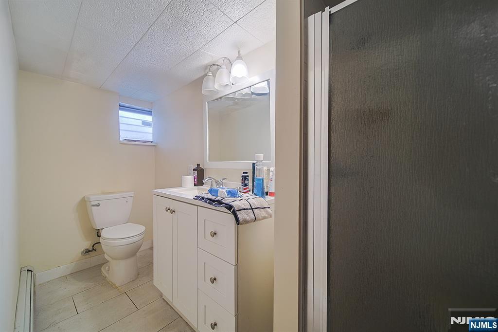 1003 Cumbermeade Road Fort Lee, NJ 07024 - Photo 22 of 23 a bathroom with a toilet a sink and a mirror
