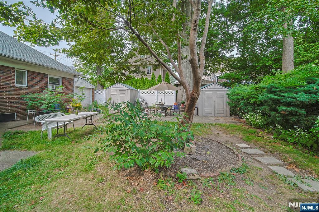 1003 Cumbermeade Road Fort Lee, NJ 07024 - Photo 23 of 23 a view of a chair and table in backyard of the house