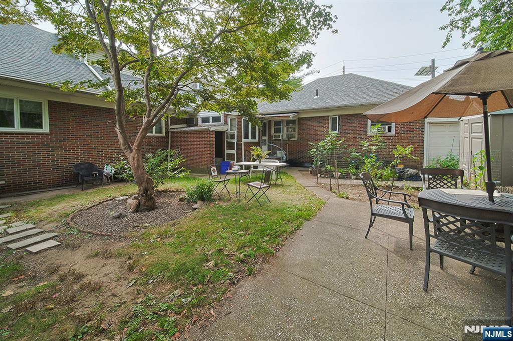 1003 Cumbermeade Road Fort Lee, NJ 07024 - Photo 5 of 23 a view of a house with backyard sitting area and garden
