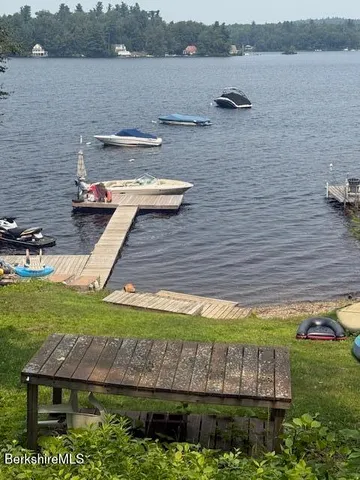 a view of a lake with a yard and outdoor seating