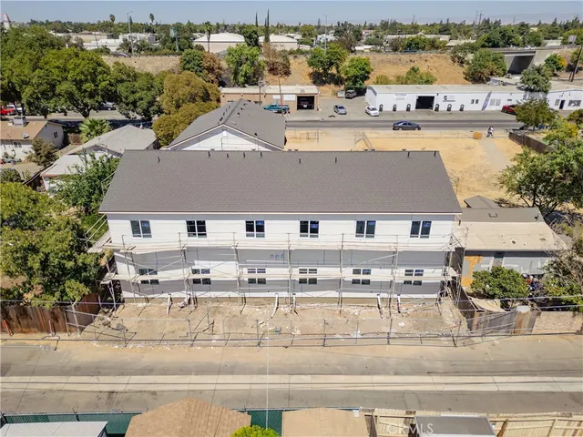 an aerial view of residential houses with outdoor space