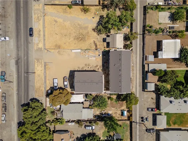 an aerial view of a residential apartment building with a yard