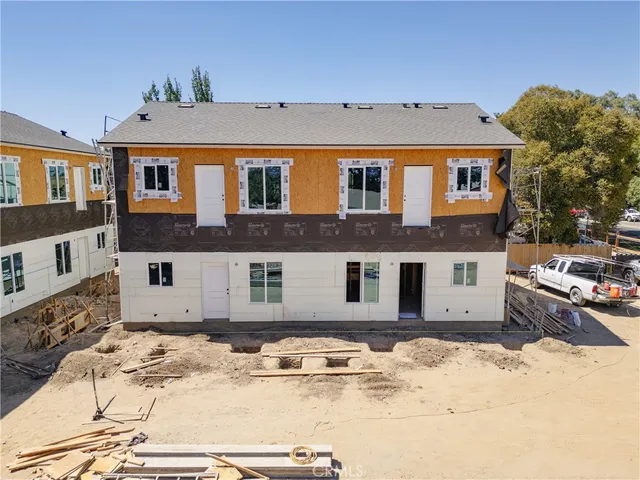 a view of a white house with a yard and covered with snow