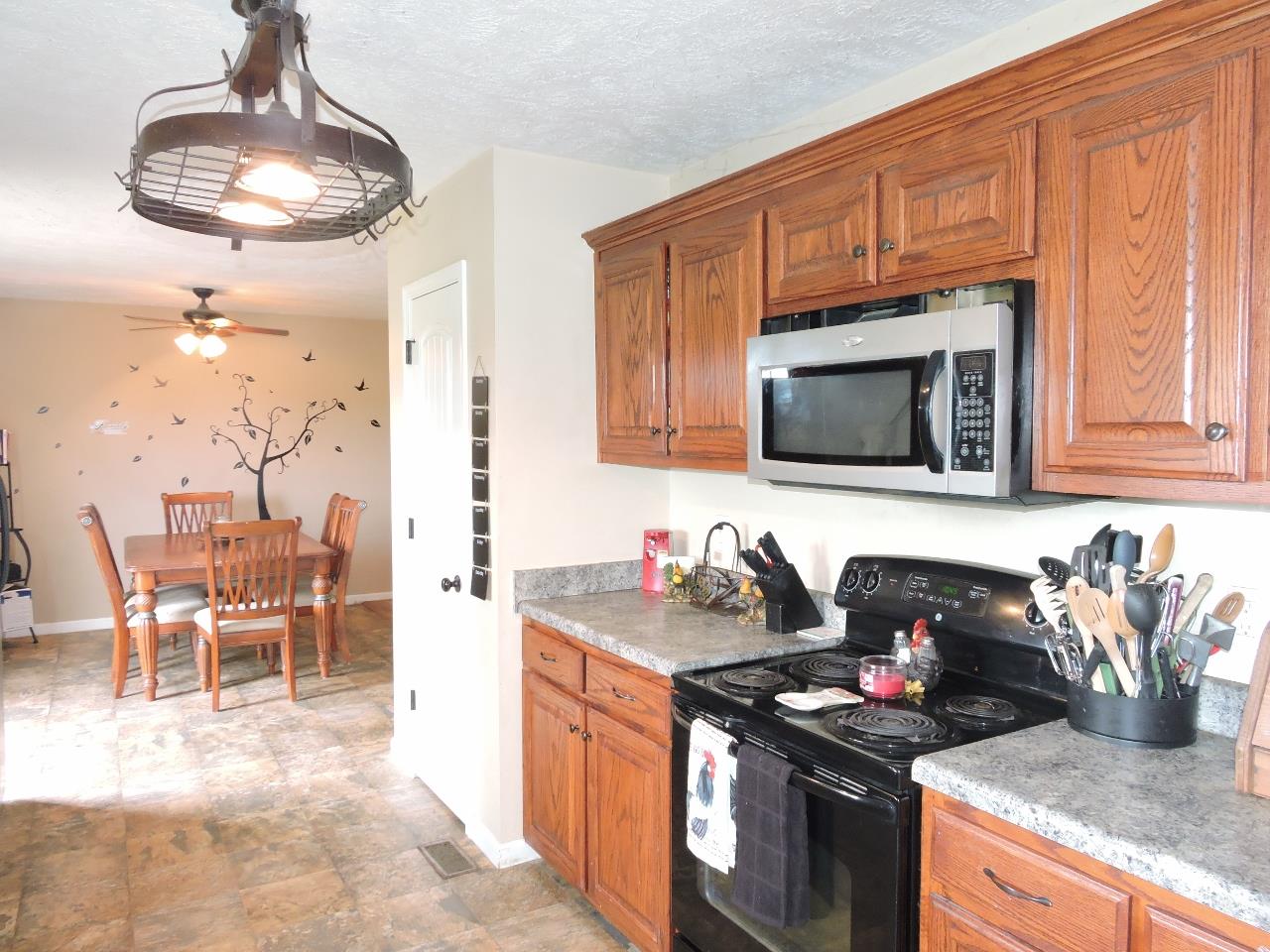 259 Bell Road Morrison, TN 37357 - Photo 11 of 27 a kitchen with stainless steel appliances granite countertop a sink stove and microwave
