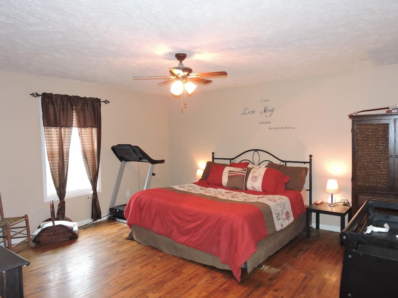 259 Bell Road Morrison, TN 37357 - Photo 12 of 27 a bedroom with a bed and a chandelier