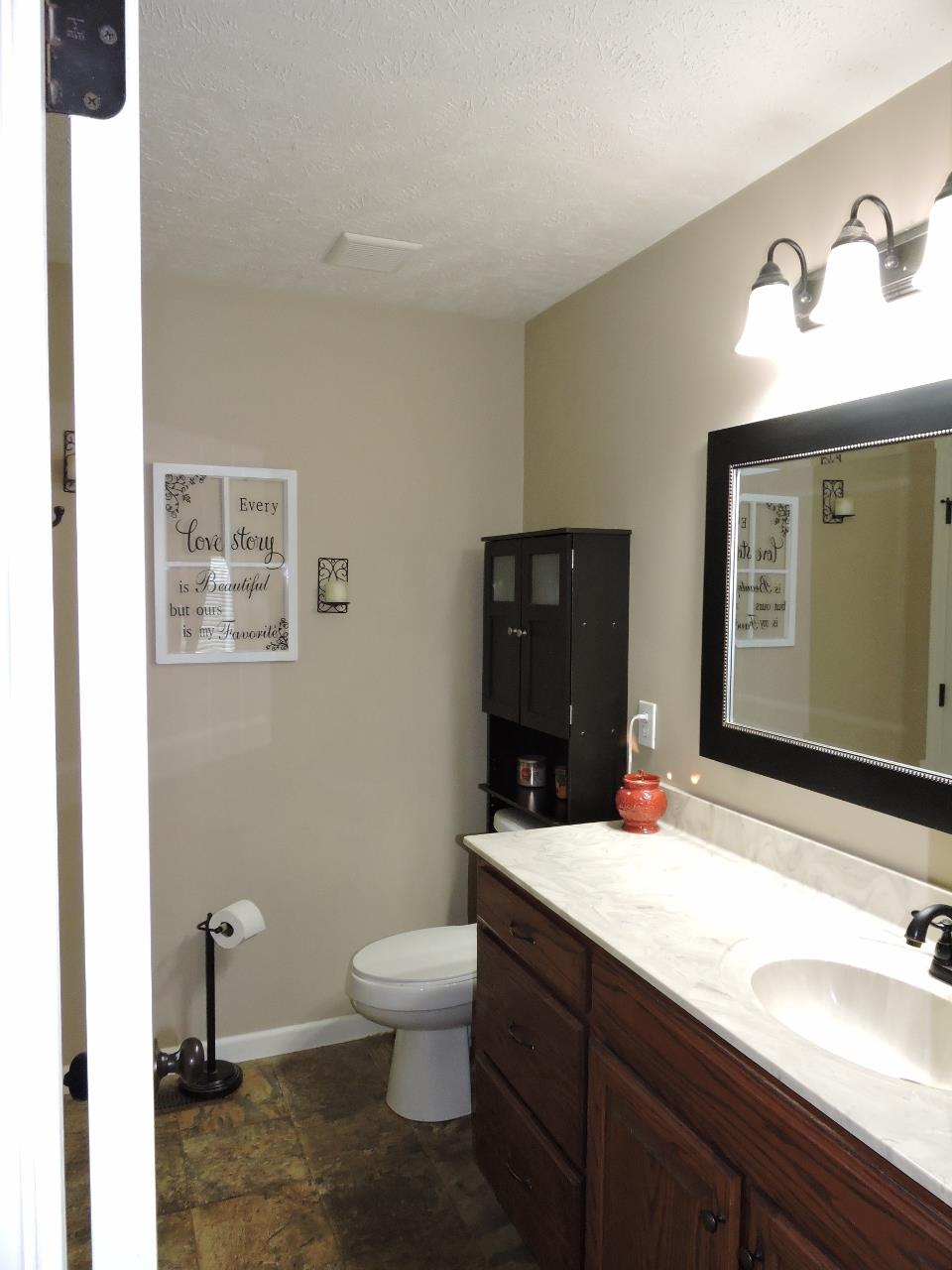 259 Bell Road Morrison, TN 37357 - Photo 15 of 27 a bathroom with a double vanity sink toilet and mirror